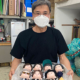 마스크를 쓰고, 가지런히 놓인 인형 상자를 들고 있는 김우찬 감독. BTS(방탄소년단)의 뮤직비디오에 사용된 인형들이다.